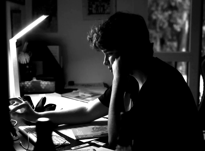 a man sitting at a desk in front of a computer